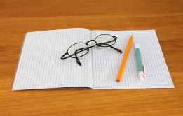 black framed eyeglass on graphing paper
